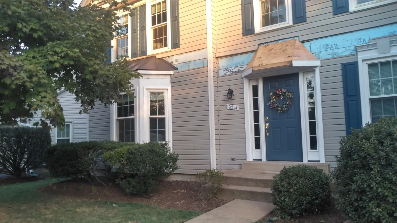 Front entry with wood decking exposed above the door before metal goes on.