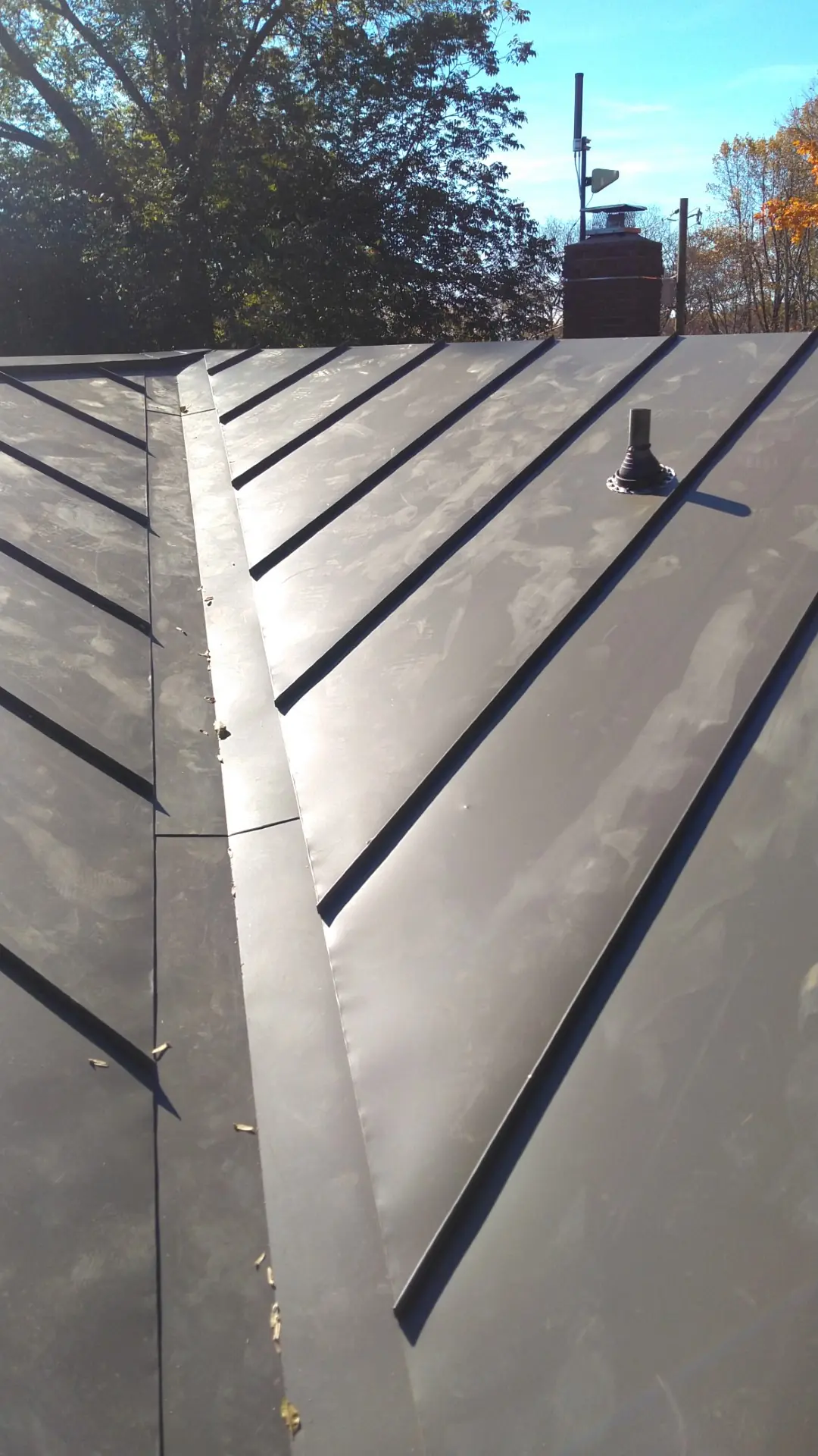 Bronze standing seam ridge and panel run seen from the roof.