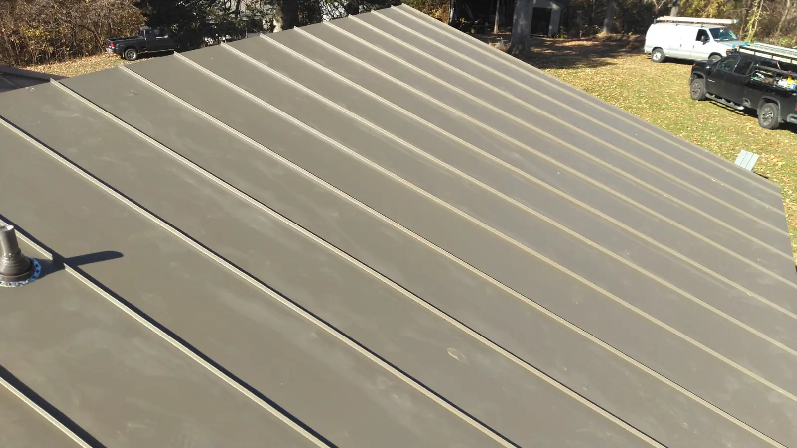Medium bronze standing seam panels with a vent boot.