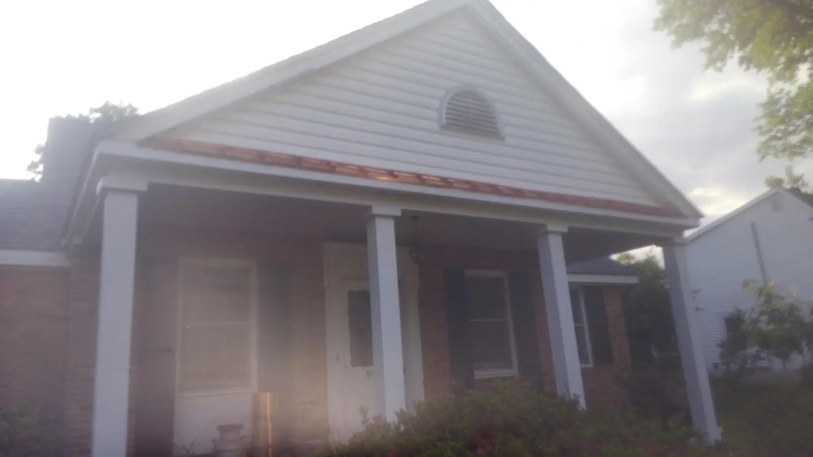 Copper roof over a front porch on a gabled home.