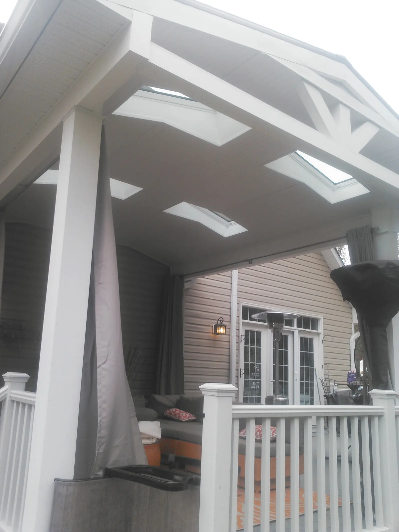White porch roof structure with skylights above.