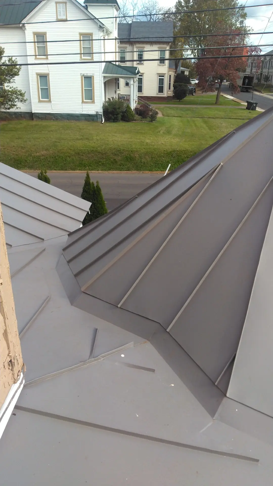 Slate gray standing seam valley beside the gazebo roof.