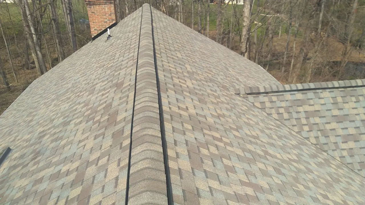 Looking along the ridge of a weathered wood blend architectural shingle roof.
